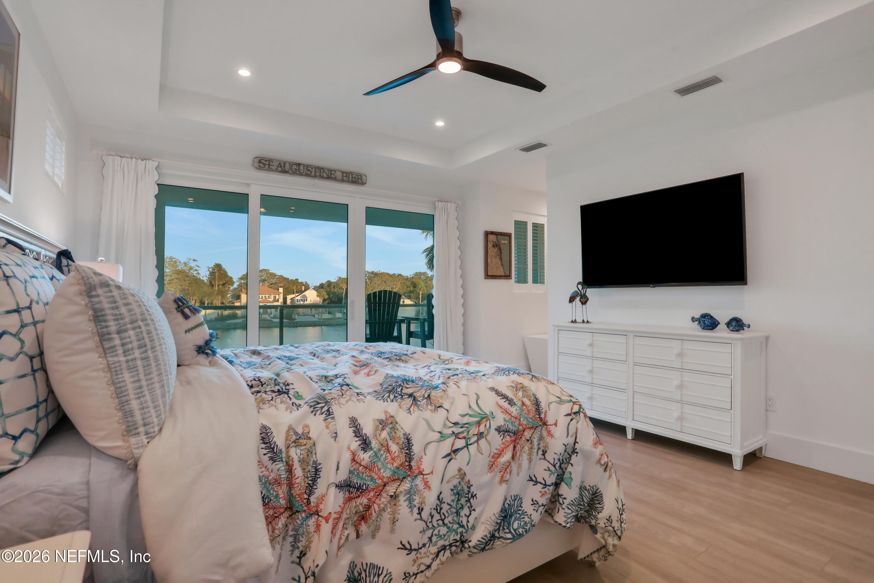 143 Washington Street St. Augustine, FL 32084 - Photo 32 of 76 a bedroom with a bed and a flat screen tv
