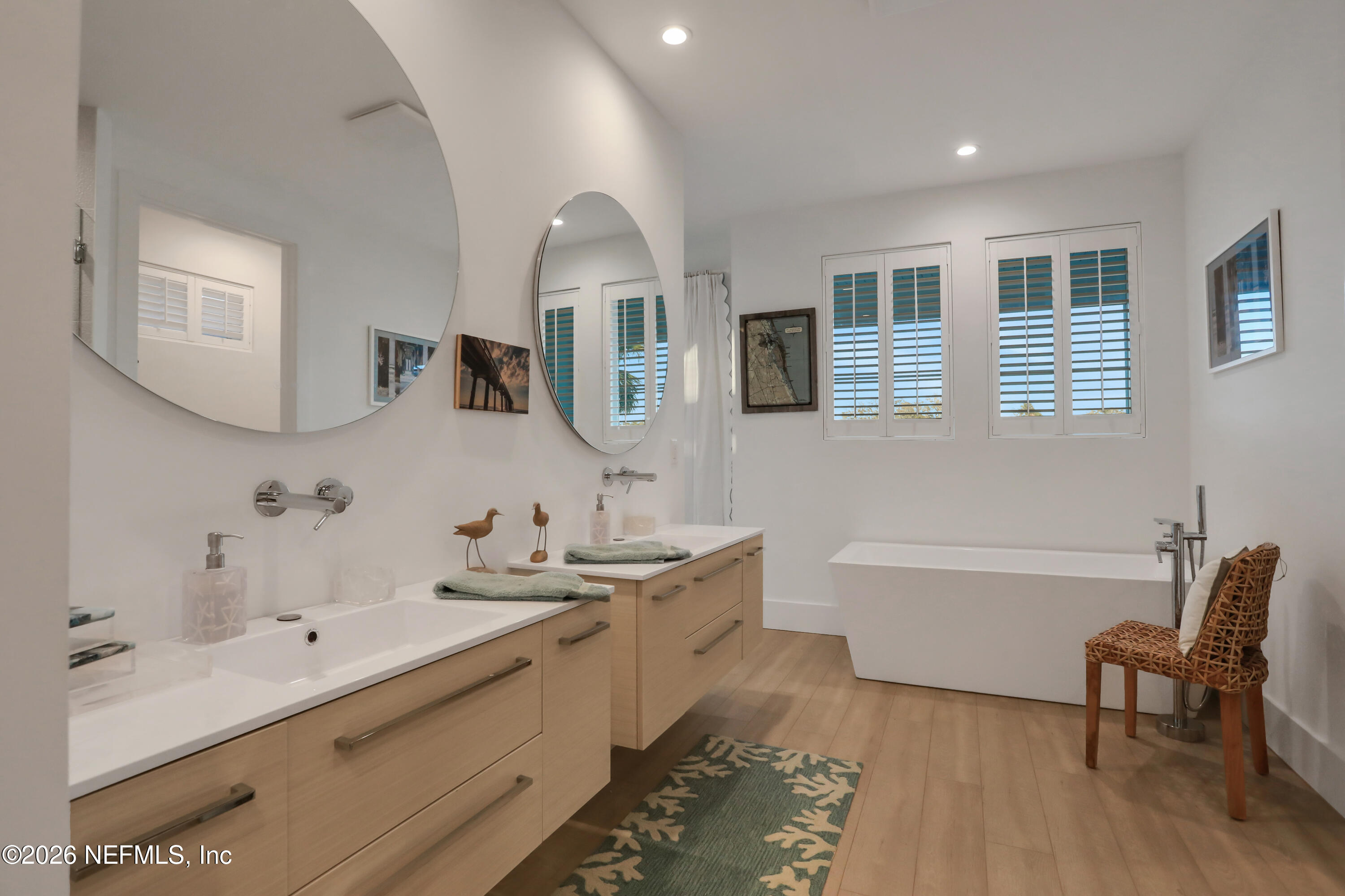 143 Washington Street St. Augustine, FL 32084 - Photo 36 of 76 a bathroom with a double vanity sink mirror and bathtub