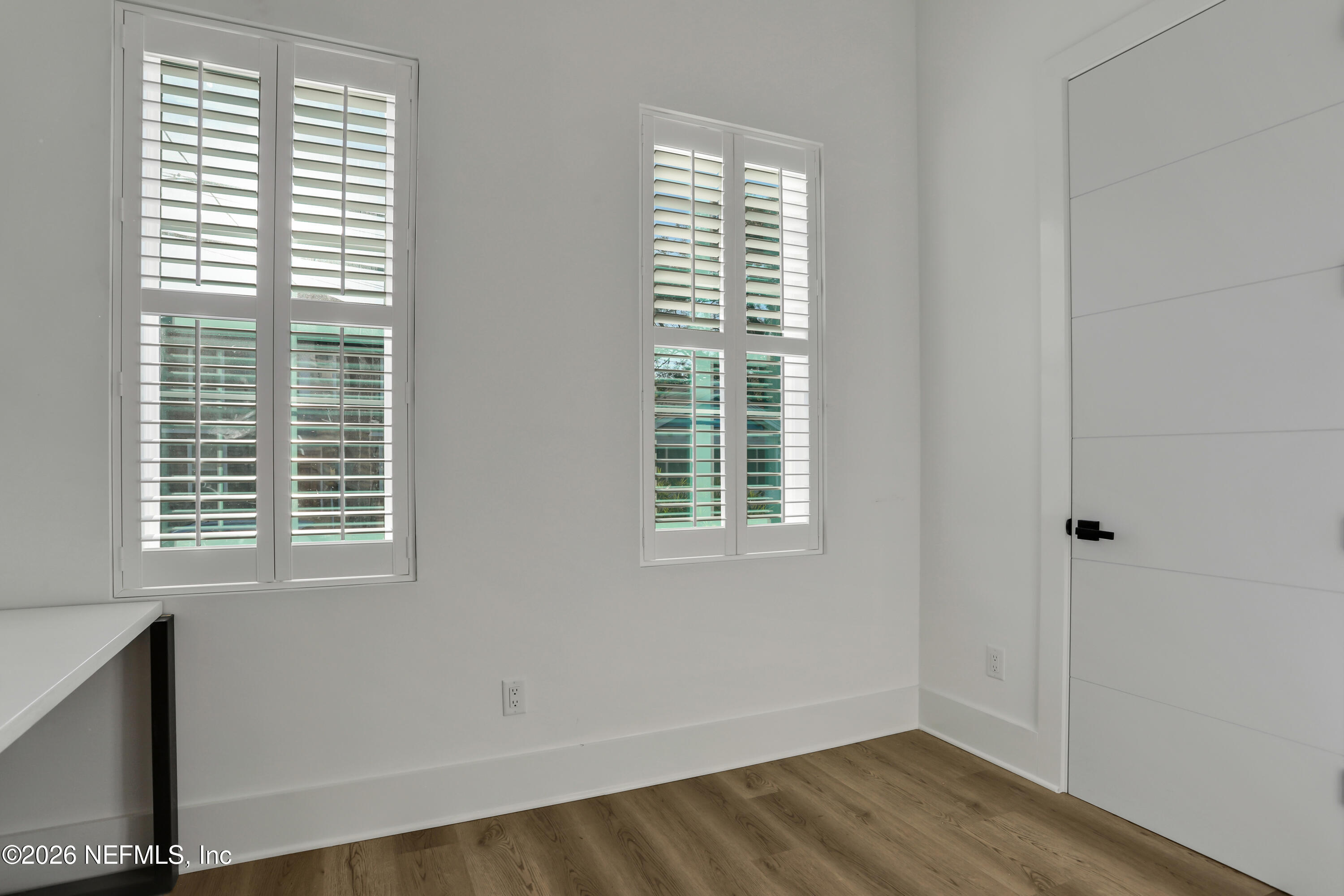 143 Washington Street St. Augustine, FL 32084 - Photo 43 of 76 a view of an empty room with wooden floor and a window