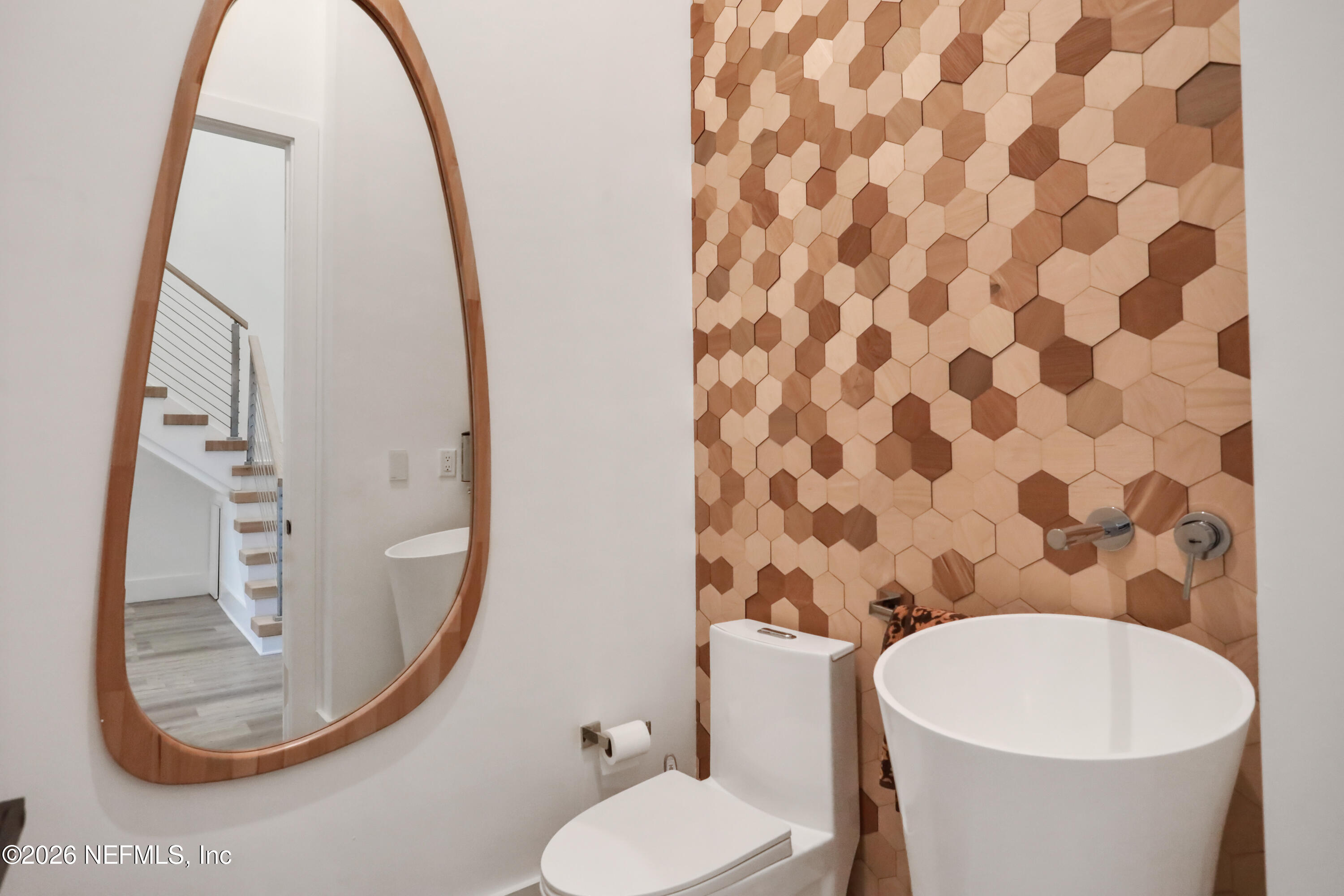 143 Washington Street St. Augustine, FL 32084 - Photo 50 of 76 a bathroom with a toilet and a mirror