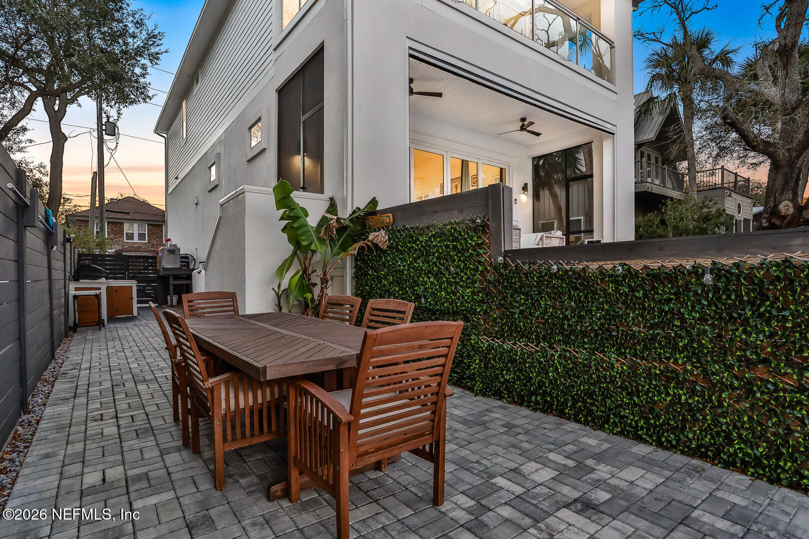 143 Washington Street St. Augustine, FL 32084 - Photo 62 of 76 a view of a wooden dinning table and chairs in patio