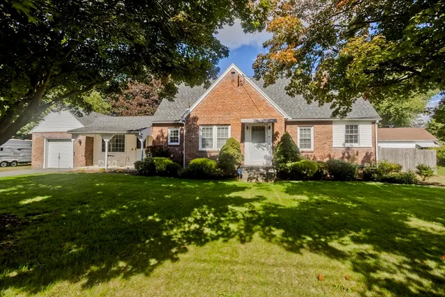 a front view of a house with a garden
