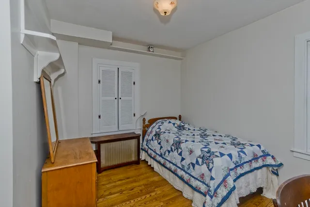 a bedroom with a bed and a dresser