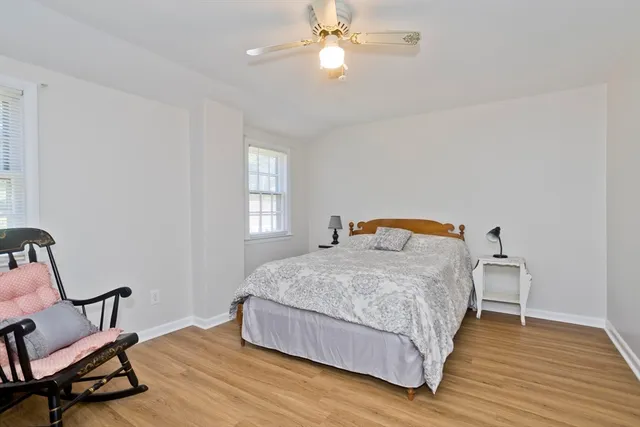 a bedroom with a bed chair and window