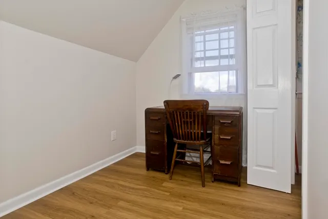 a dining room with furniture and wooden floor