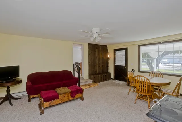 a livingroom with workspace and a couch