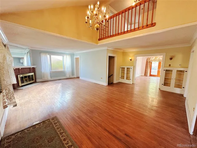 a view of a livingroom with wooden floor and stairs