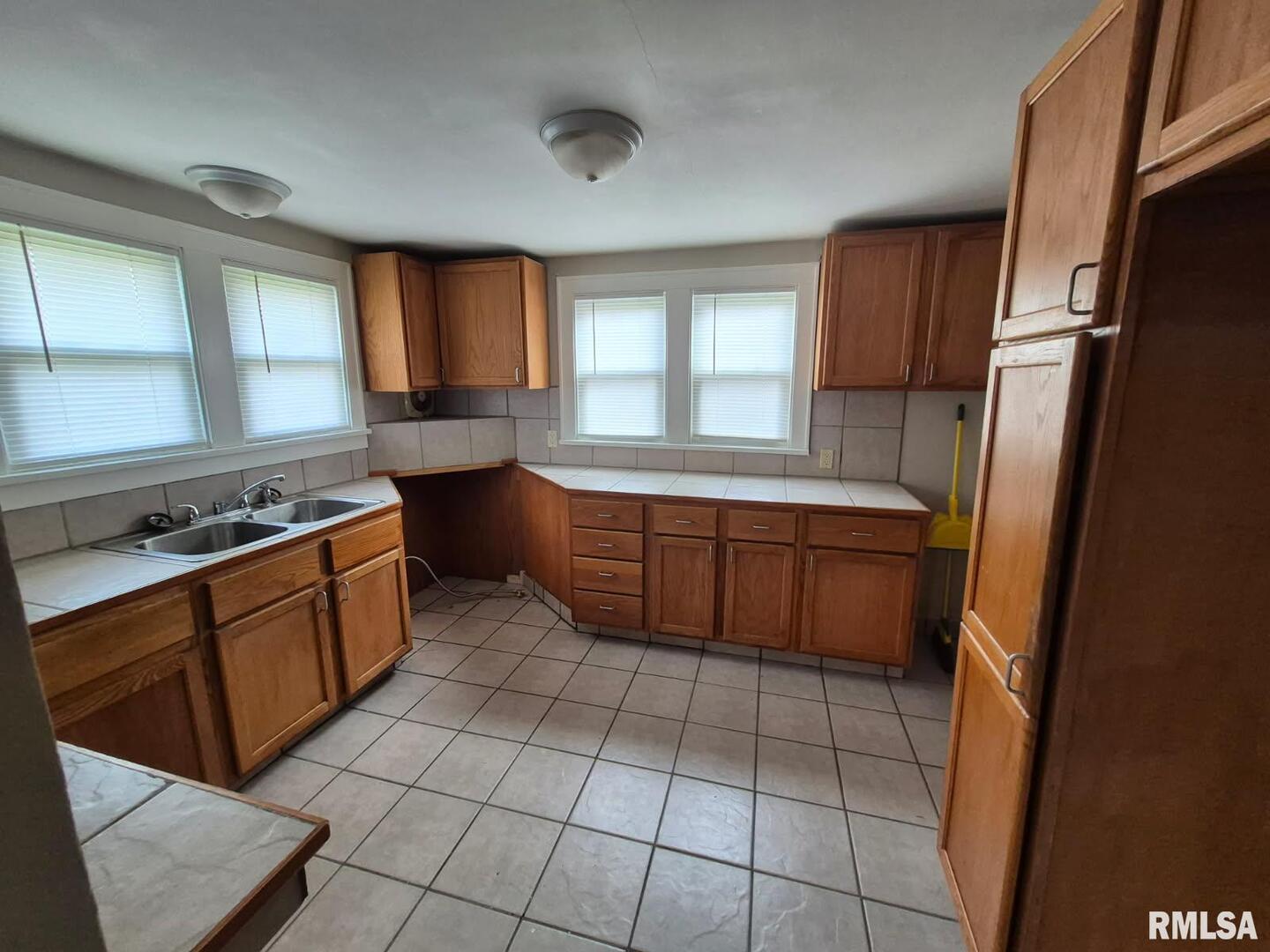 548 Edwards Street Kewanee, IL 61443 - Photo 2 of 18 a kitchen with a sink a stove cabinets and a window