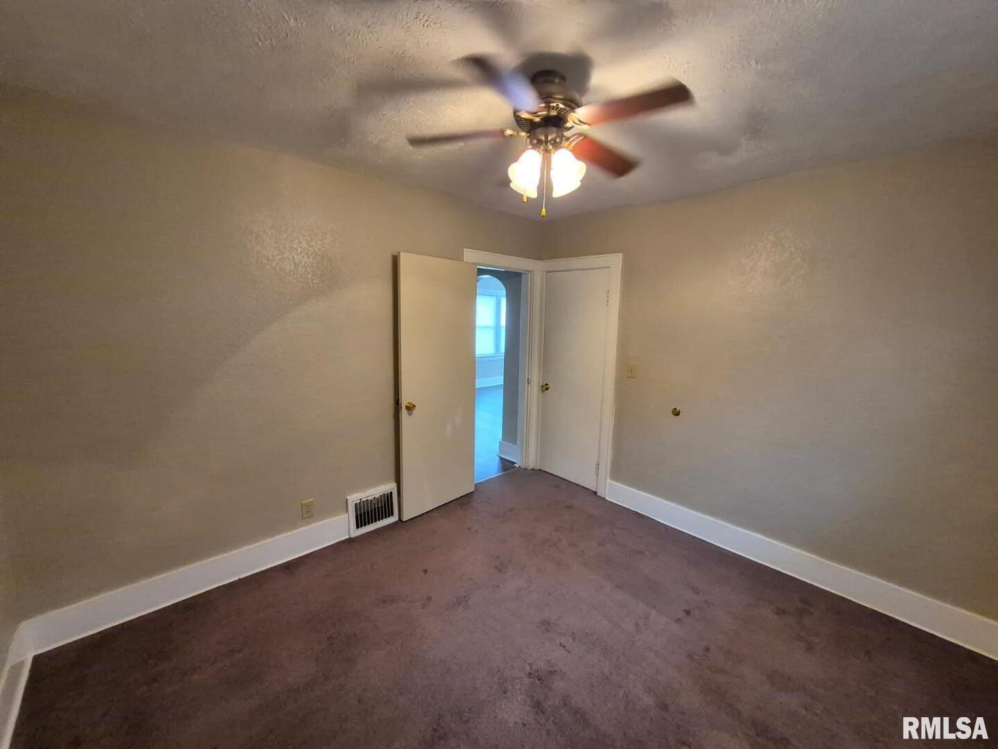 548 Edwards Street Kewanee, IL 61443 - Photo 5 of 18 an empty room with closet and a chandelier fan