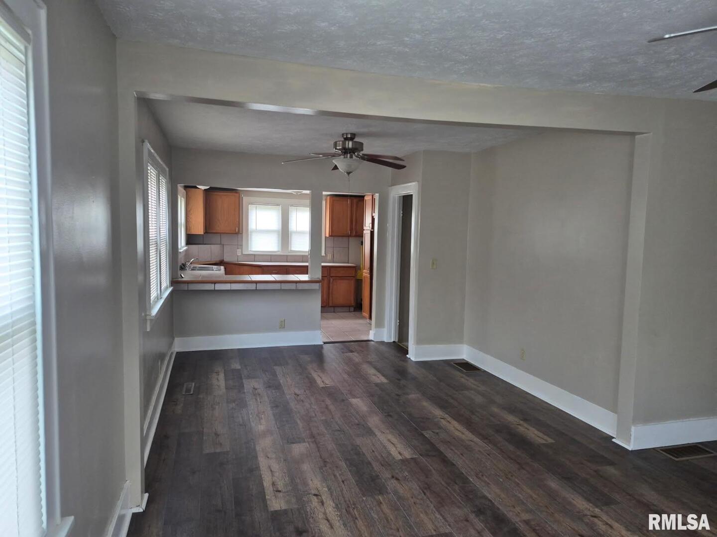 548 Edwards Street Kewanee, IL 61443 - Photo 6 of 18 a view of a hallway with wooden floor and a kitchen