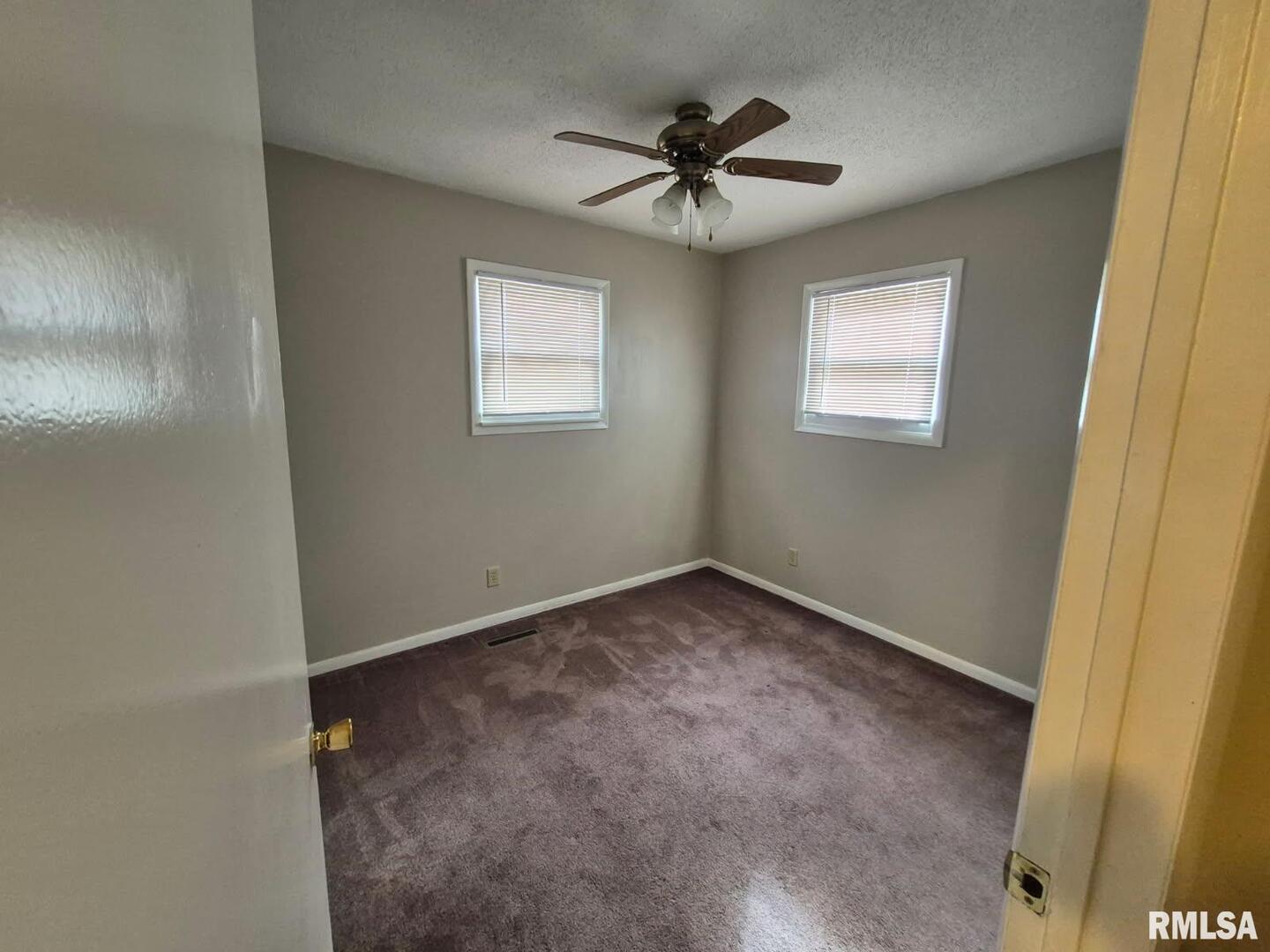 548 Edwards Street Kewanee, IL 61443 - Photo 9 of 18 a view of a big room with wooden floor and windows