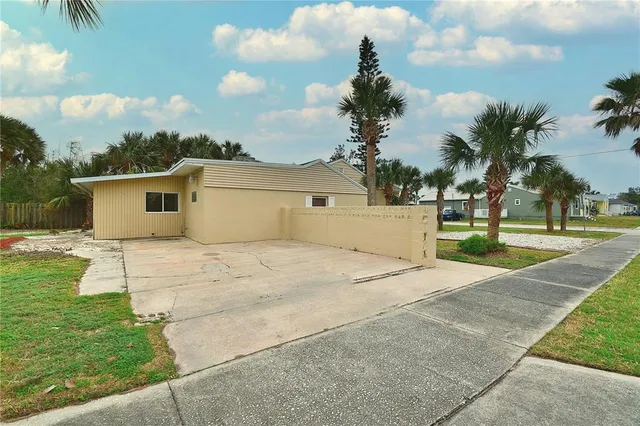 a front view of a house with a garden and yard