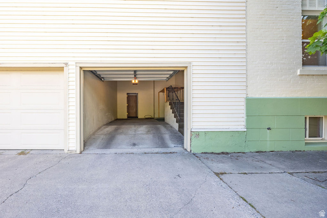 299 West Center Street, Unit 2 Logan, UT 84321 - Photo 28 of 46 Two-car garage featuring a roll-up door, interior lighting, and a concrete driveway