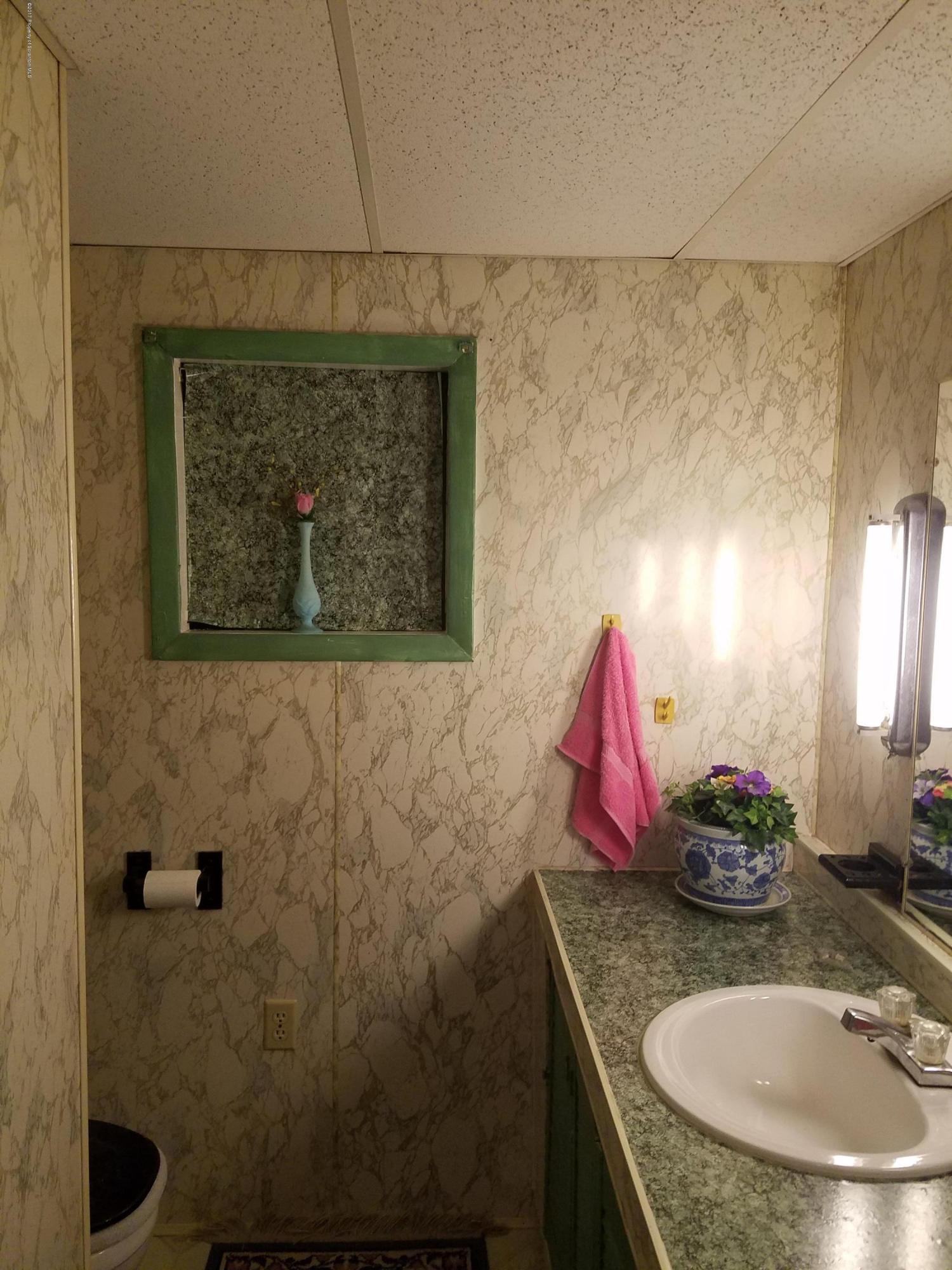 477 Randolph Road Great Bend, PA 18821 - Photo 16 of 23 a bathroom with a granite countertop sink a mirror and shower