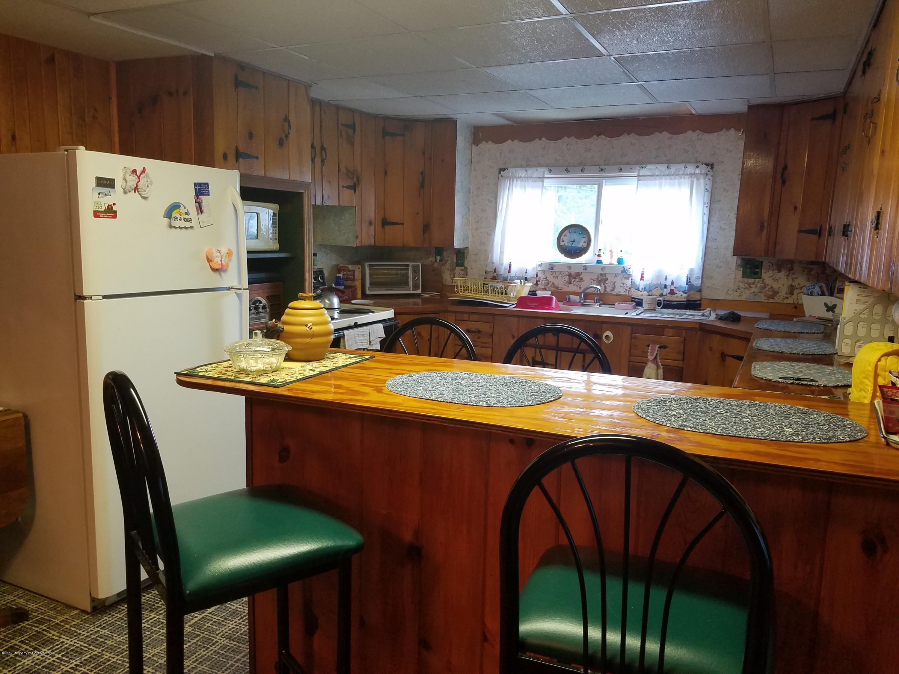 477 Randolph Road Great Bend, PA 18821 - Photo 4 of 23 a kitchen with a table chairs refrigerator and cabinets