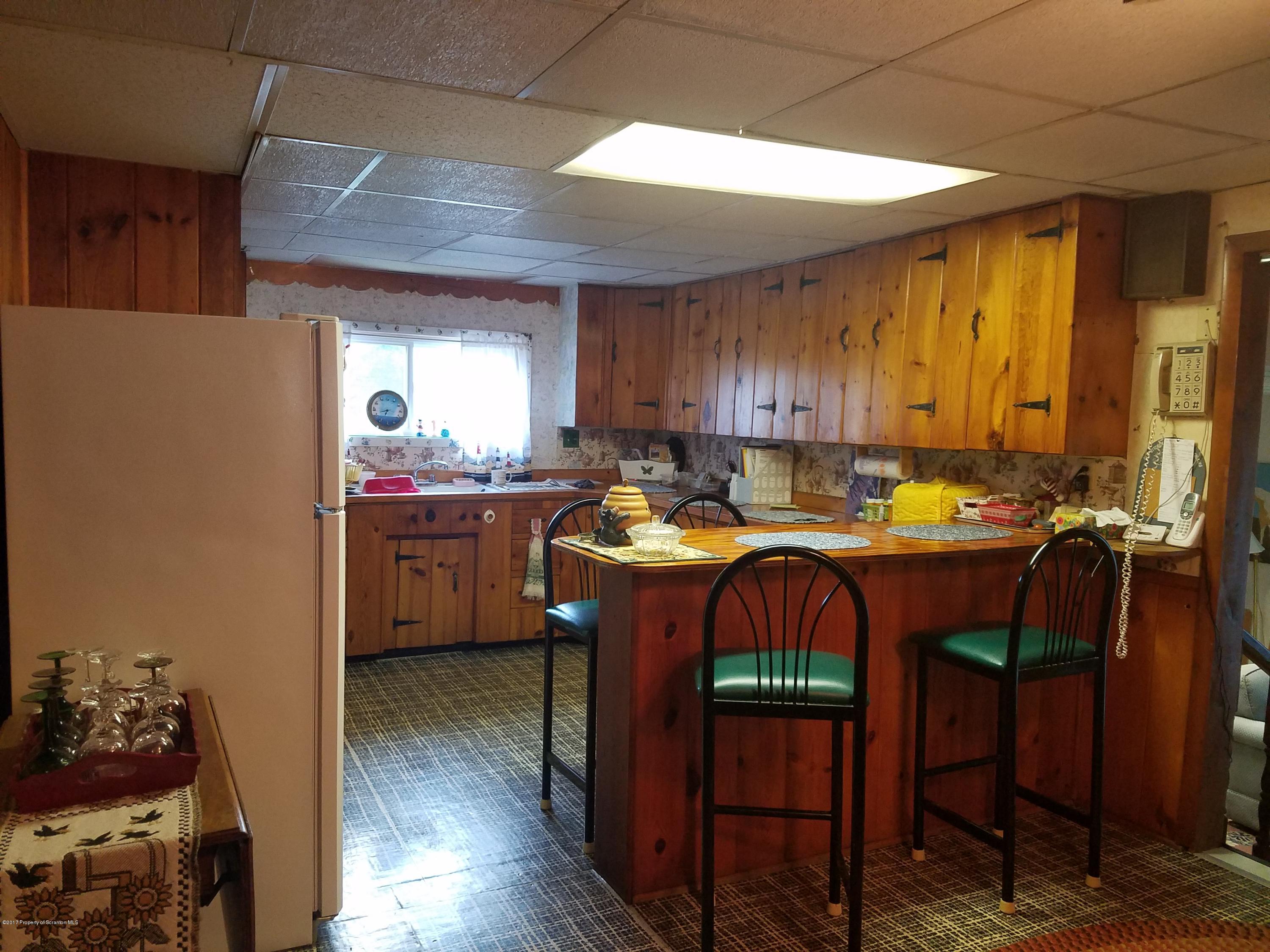 477 Randolph Road Great Bend, PA 18821 - Photo 5 of 23 a kitchen with a cabinets appliances and a dining table