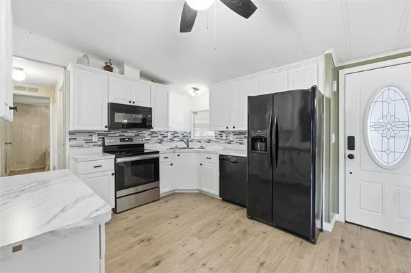 a kitchen with a refrigerator stove and sink