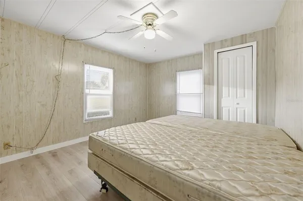 a bedroom with a bed and a chandelier