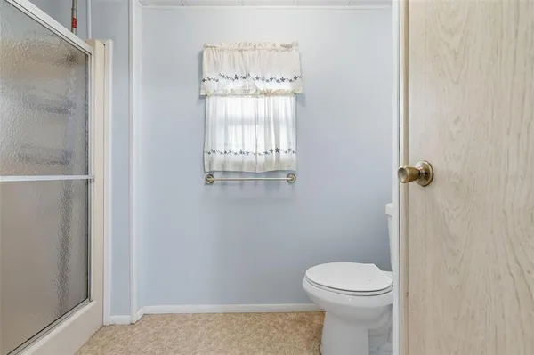 a bathroom with a toilet and a shower