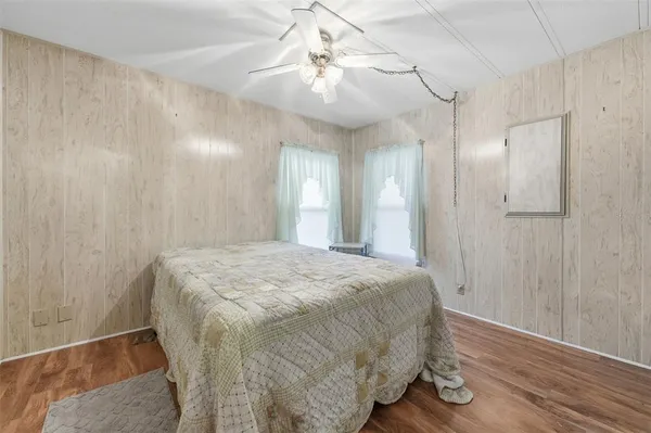a spacious bedroom with a bed and a chandelier