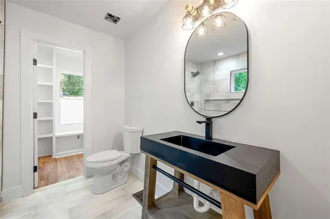 a front view of a house with a sink and a mirror