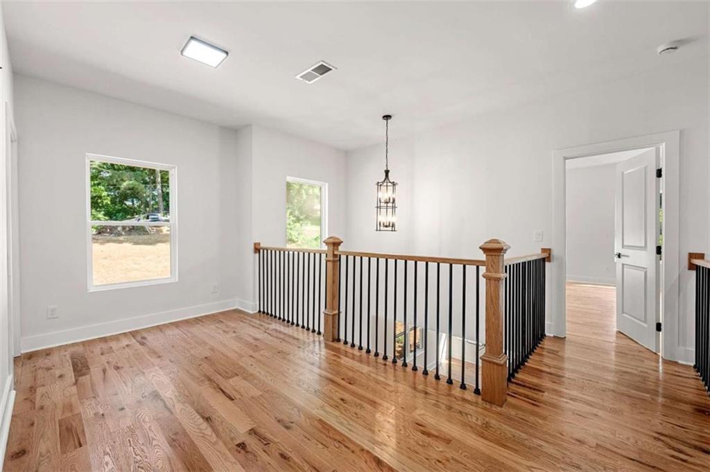 1606 Blvd Lorraine Southwest Atlanta, GA 30311 - Photo 16 of 24 wooden floor in an empty room with a window