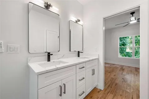 a bathroom with a double vanity sink and mirror