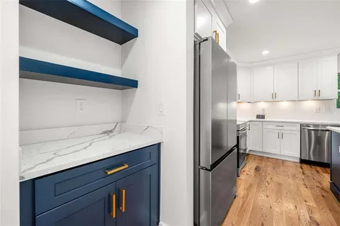 a kitchen with stainless steel appliances a sink and a refrigerator