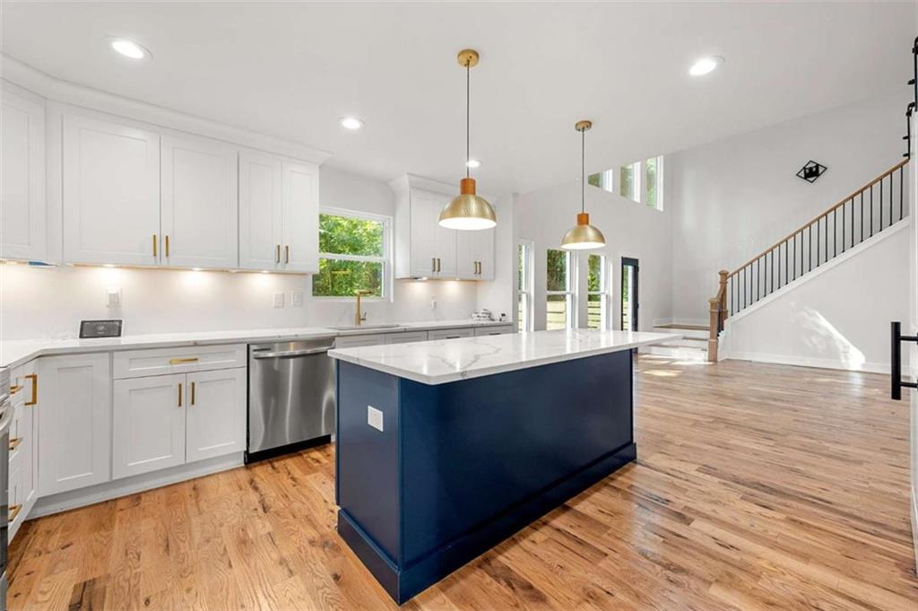 1606 Blvd Lorraine Southwest Atlanta, GA 30311 - Photo 5 of 24 a kitchen with kitchen island granite countertop a sink and a stove