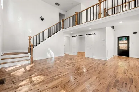 a view of empty room with wooden floor