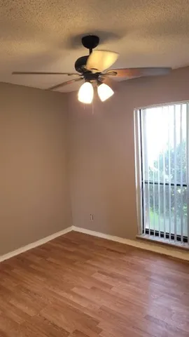 a view of a room with wooden floor and windows