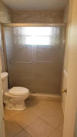 a bathroom with a toilet and a shower