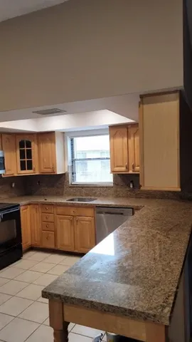 a kitchen with stainless steel appliances granite countertop a sink and a granite counter tops