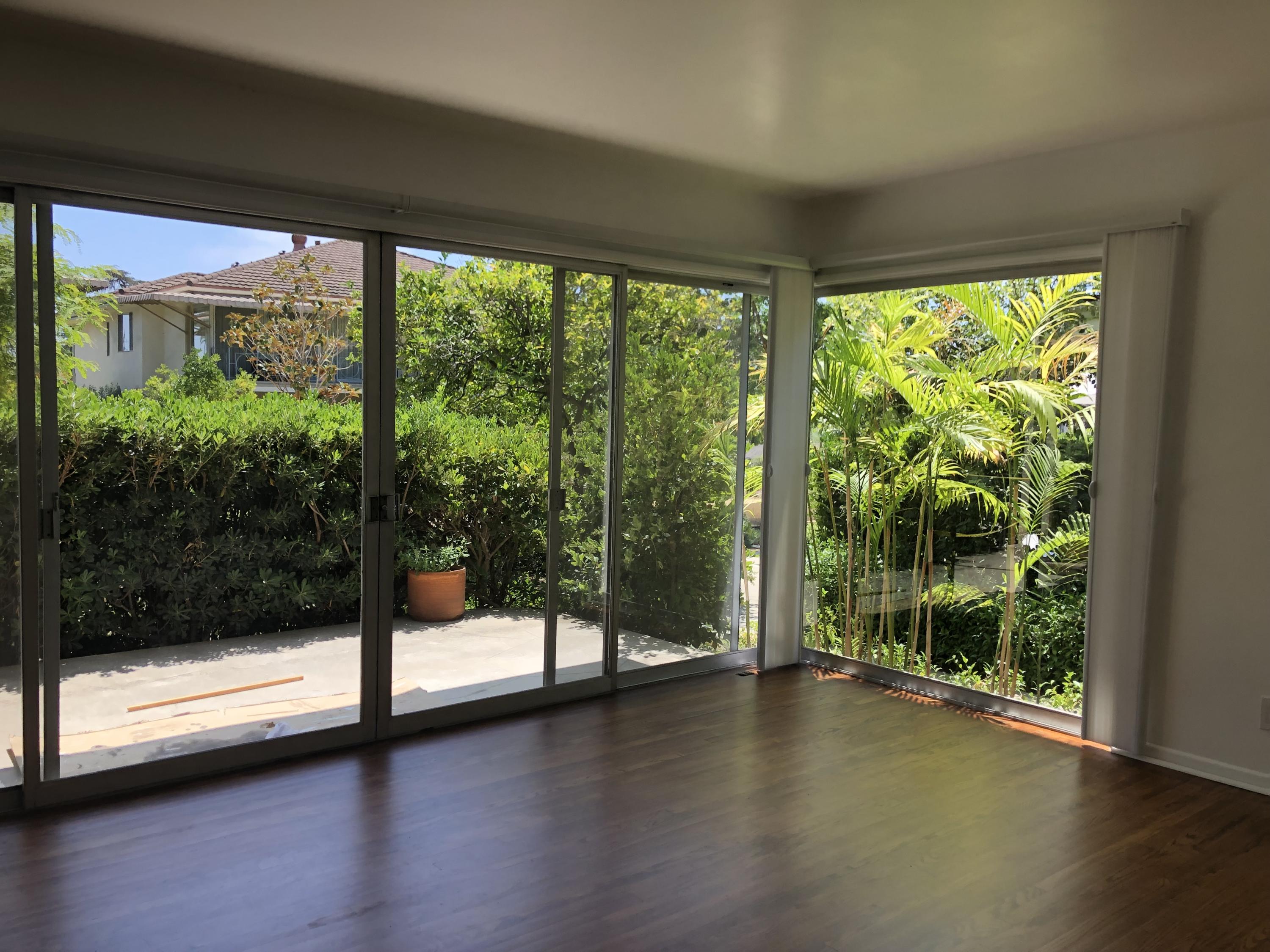 2030 State Street Santa Barbara, CA 93105 - Photo 2 of 7 a view of empty room with wooden floor and floor to ceiling window