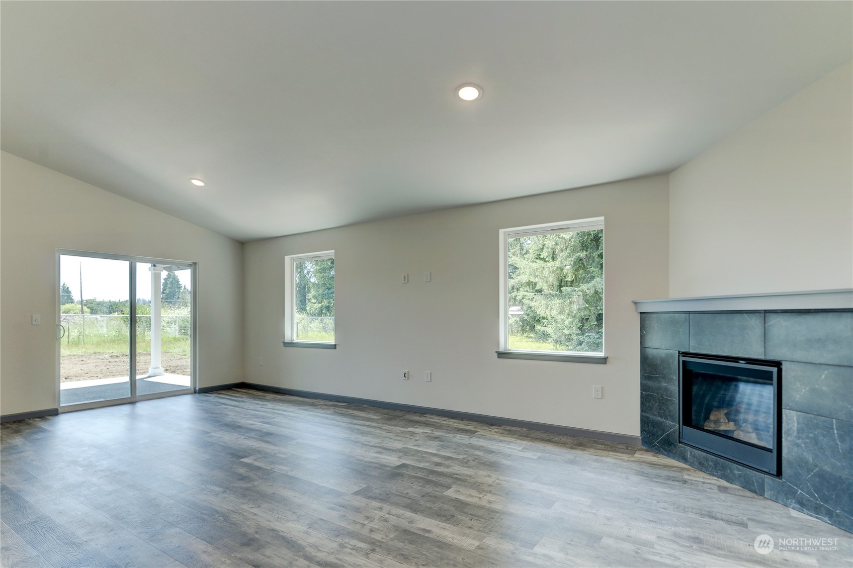 10335 School Land Road Southwest Rochester, WA 98579 - Photo 16 of 35 an empty room with windows and fireplace