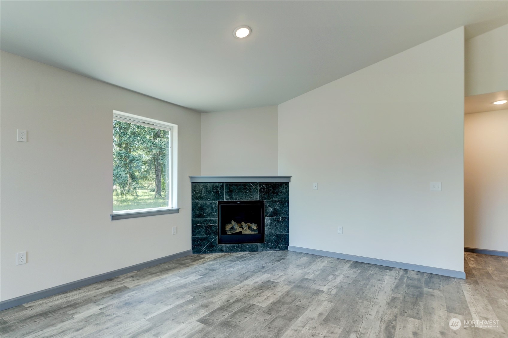 10335 School Land Road Southwest Rochester, WA 98579 - Photo 17 of 35 an empty room with windows and fireplace