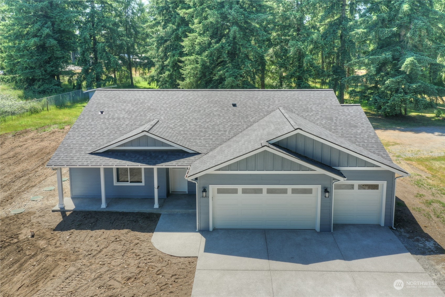 10335 School Land Road Southwest Rochester, WA 98579 - Photo 3 of 35 a house with trees in the background