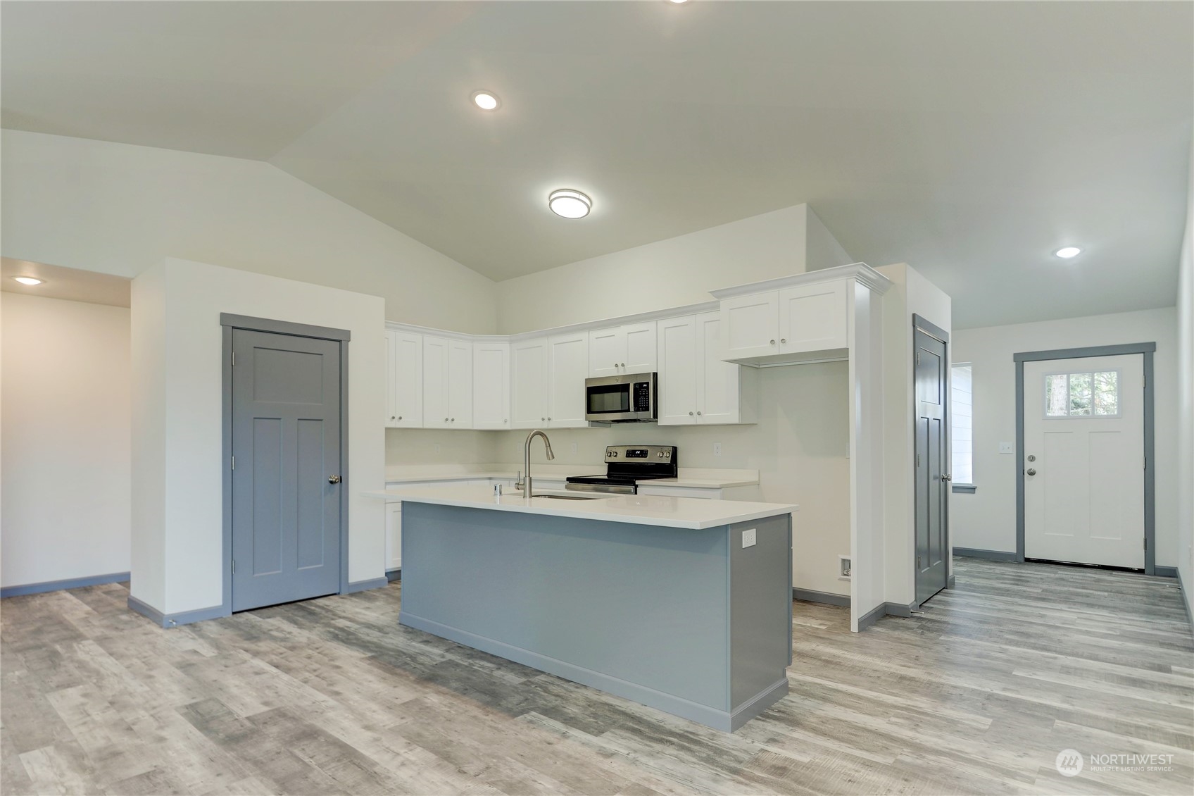 10335 School Land Road Southwest Rochester, WA 98579 - Photo 8 of 35 a kitchen with stainless steel appliances a sink stove and cabinets