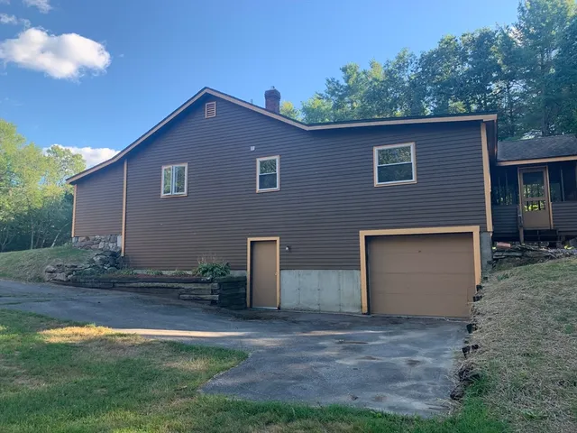 a backyard of a house with yard and garage