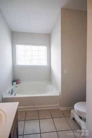 a bathroom with a bathtub and toilet