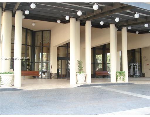 a view of a building with table and chairs