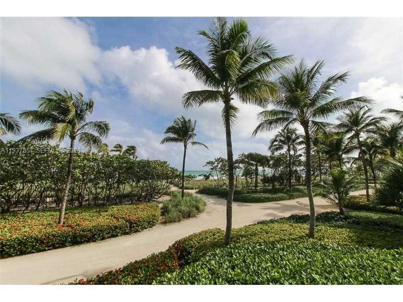 10185 Collins Avenue, Unit PH02 Bal Harbour, FL 33154 - Photo 18 of 37 a palm tree sitting in front of a yard with a fountain