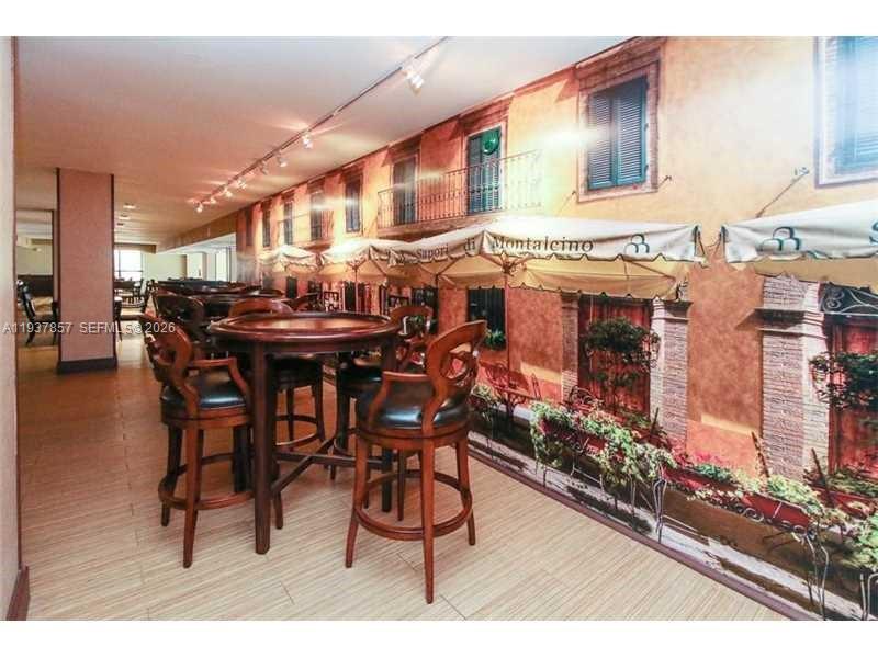 10185 Collins Avenue, Unit PH02 Bal Harbour, FL 33154 - Photo 21 of 37 a dining hall with lots of wooden furniture