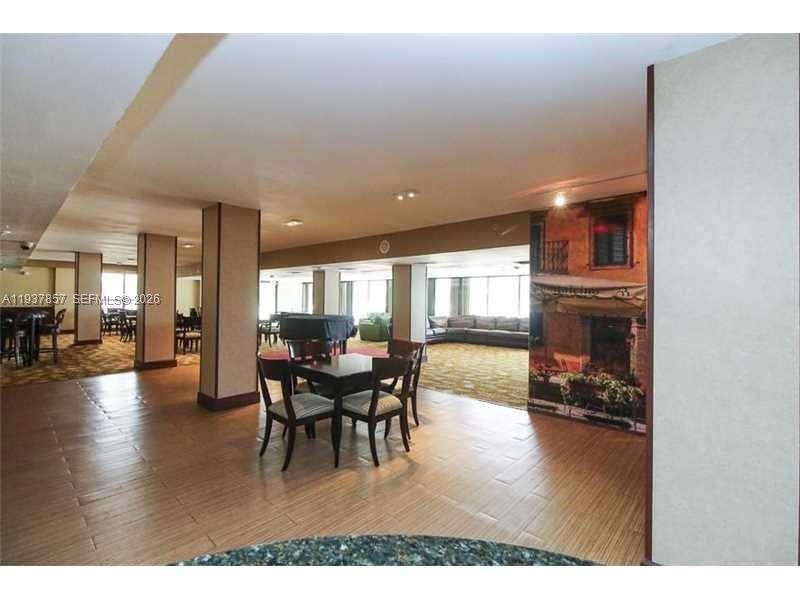 10185 Collins Avenue, Unit PH02 Bal Harbour, FL 33154 - Photo 22 of 37 a dining room with furniture and wooden floor