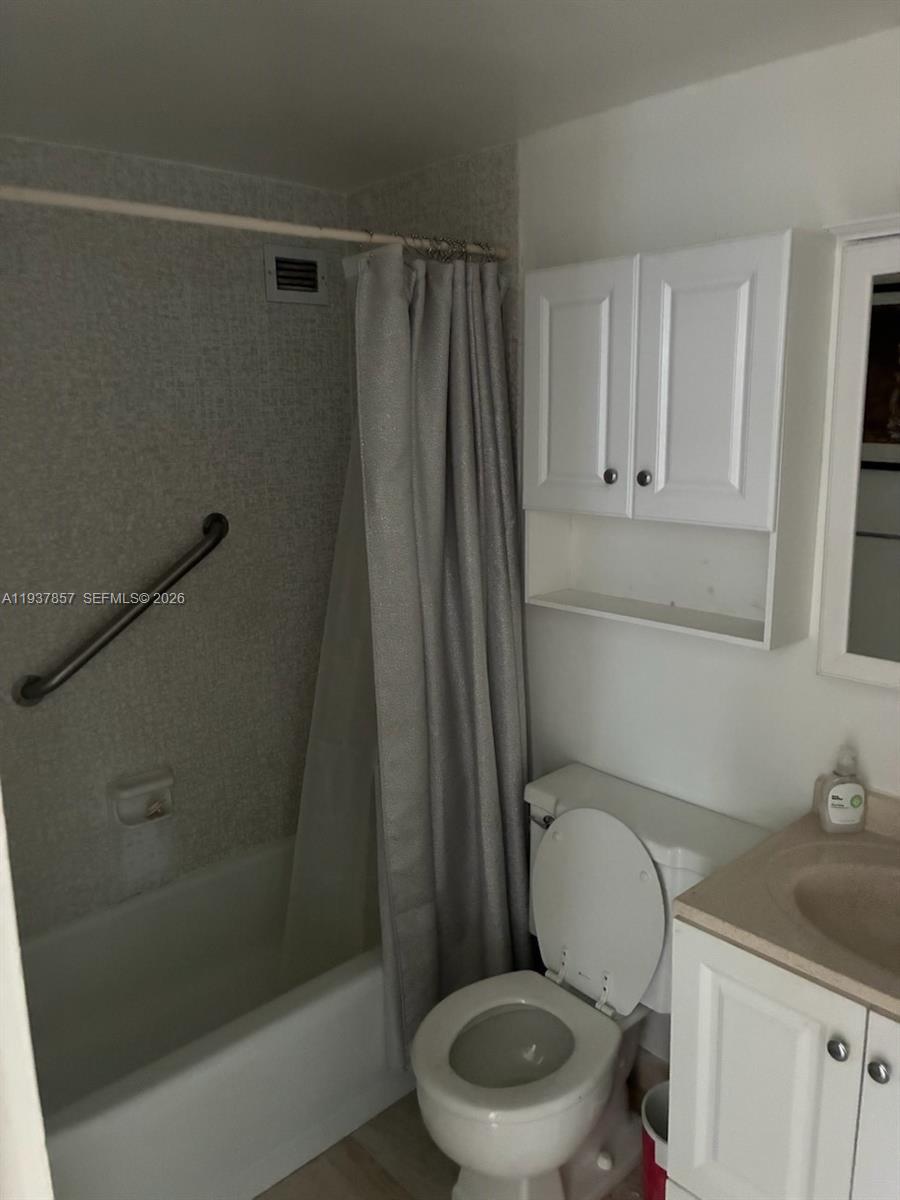 10185 Collins Avenue, Unit PH02 Bal Harbour, FL 33154 - Photo 32 of 37 a white toilet sitting next to a bathroom sink