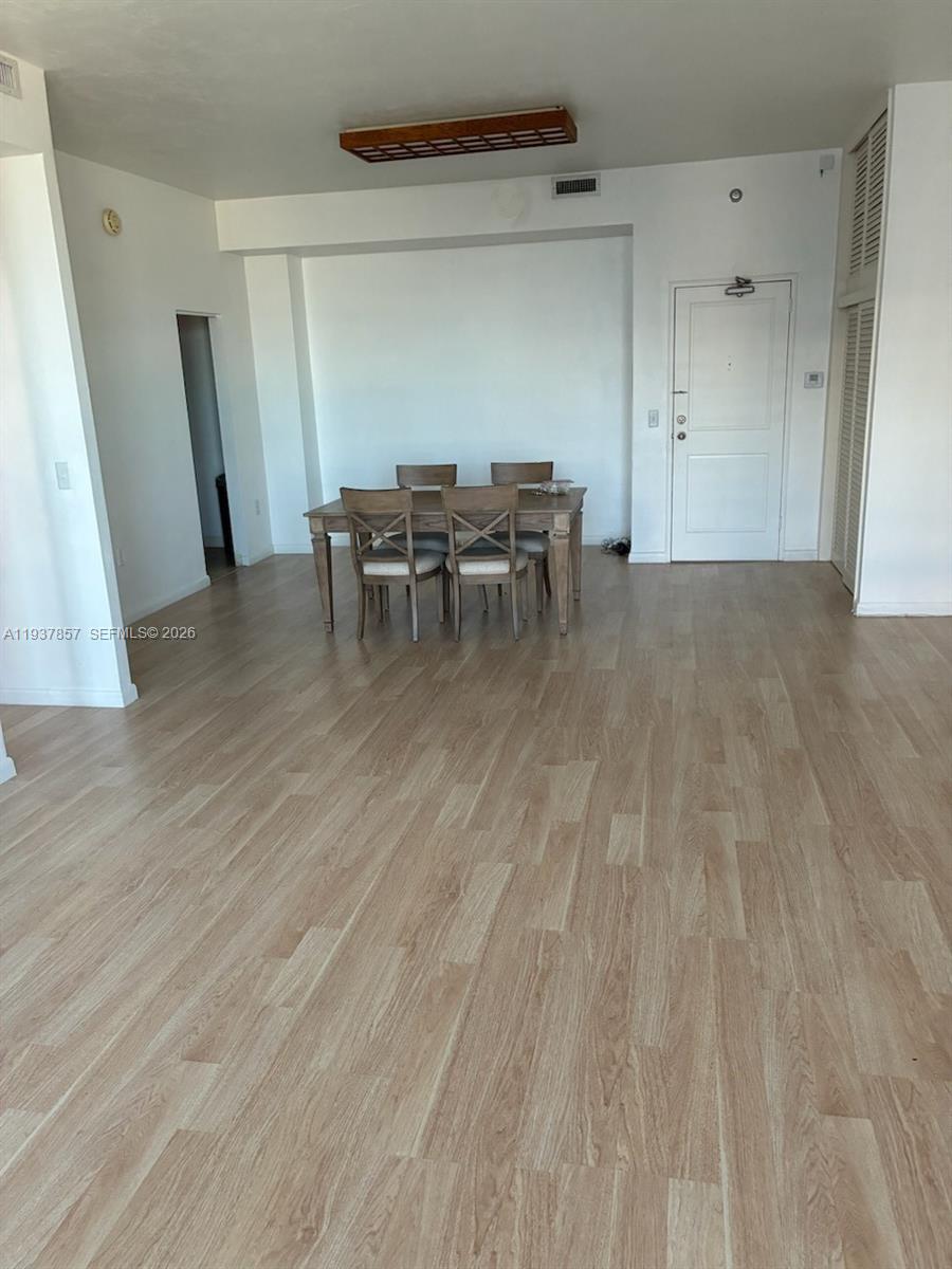 10185 Collins Avenue, Unit PH02 Bal Harbour, FL 33154 - Photo 36 of 37 a view of a livingroom with chairs and wooden floor