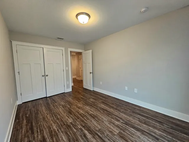 a view of an empty room and wooden floor