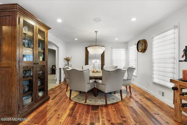 a view of a dining room with furniture wooden floor and chandelier