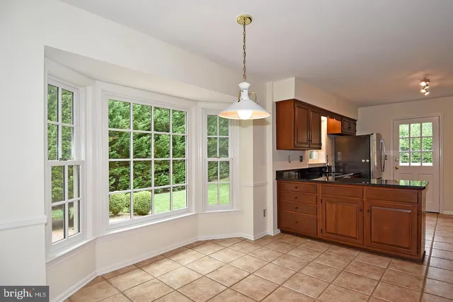 a kitchen with granite countertop a stove and a cabinets