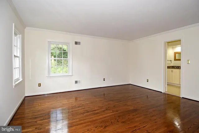 a bathroom with a granite countertop sink a mirror and a bathtub